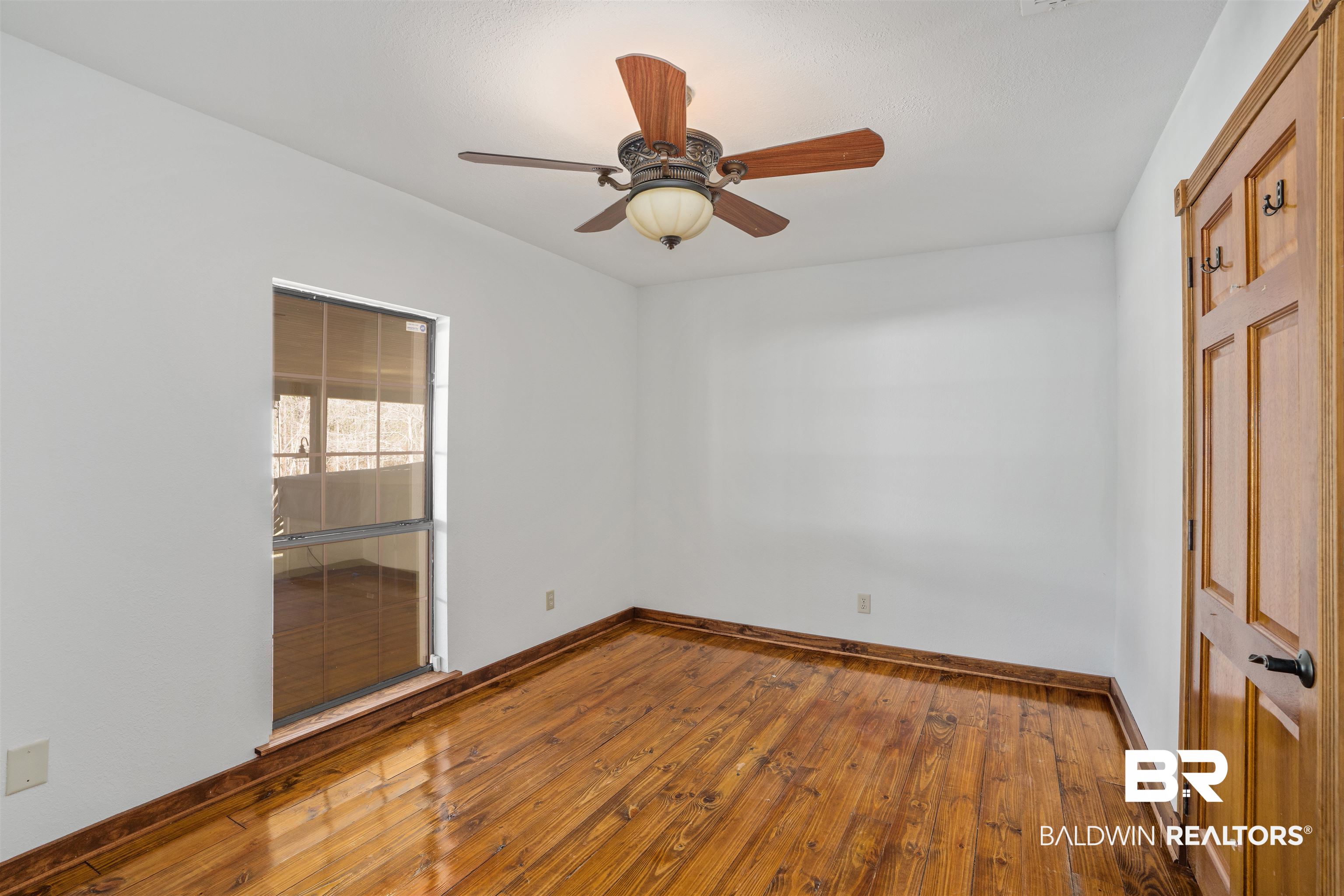51699 Highway 31 Perdido, AL 36562 - Photo 20 of 30 Spare room featuring wood finished floors, a ceiling fan, and baseboards