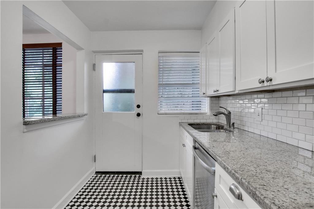 1174 Briarcliff Road Northeast, Unit 1 Atlanta, GA 30306 - Photo 11 of 24 a kitchen with a sink a stove and cabinets