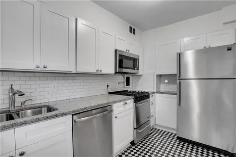a kitchen with a sink stove and refrigerator