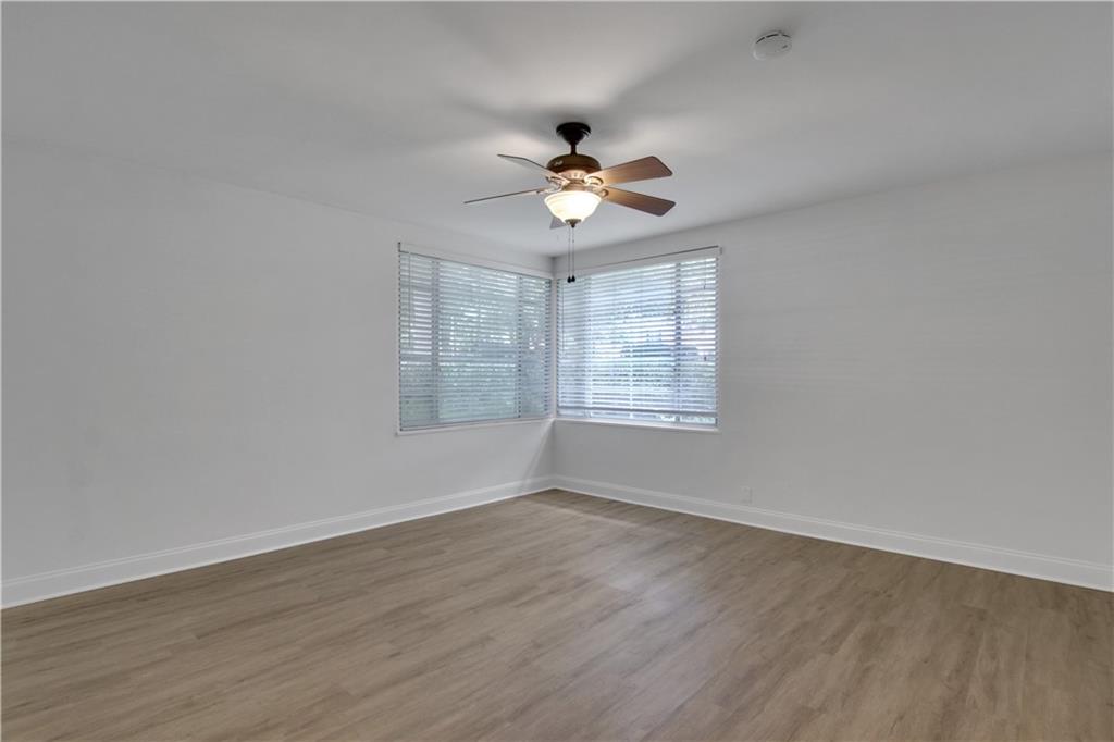 1174 Briarcliff Road Northeast, Unit 1 Atlanta, GA 30306 - Photo 14 of 24 an empty room with wooden floor ceiling fan and windows