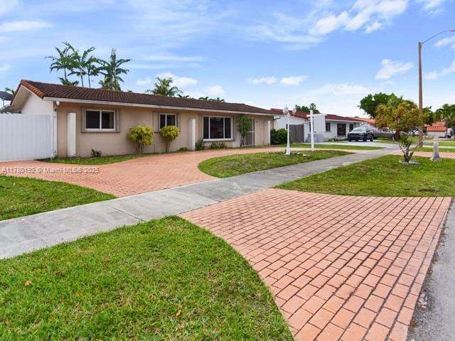 9864 Southwest 26th Terrace Miami, FL 33165 - Photo 1 of 39 a front view of a house with a yard and potted plants