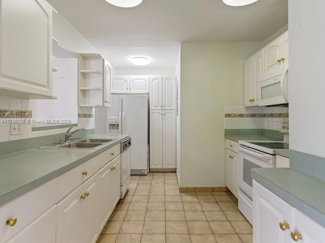 9864 Southwest 26th Terrace Miami, FL 33165 - Photo 13 of 39 a large kitchen with a stove and a sink