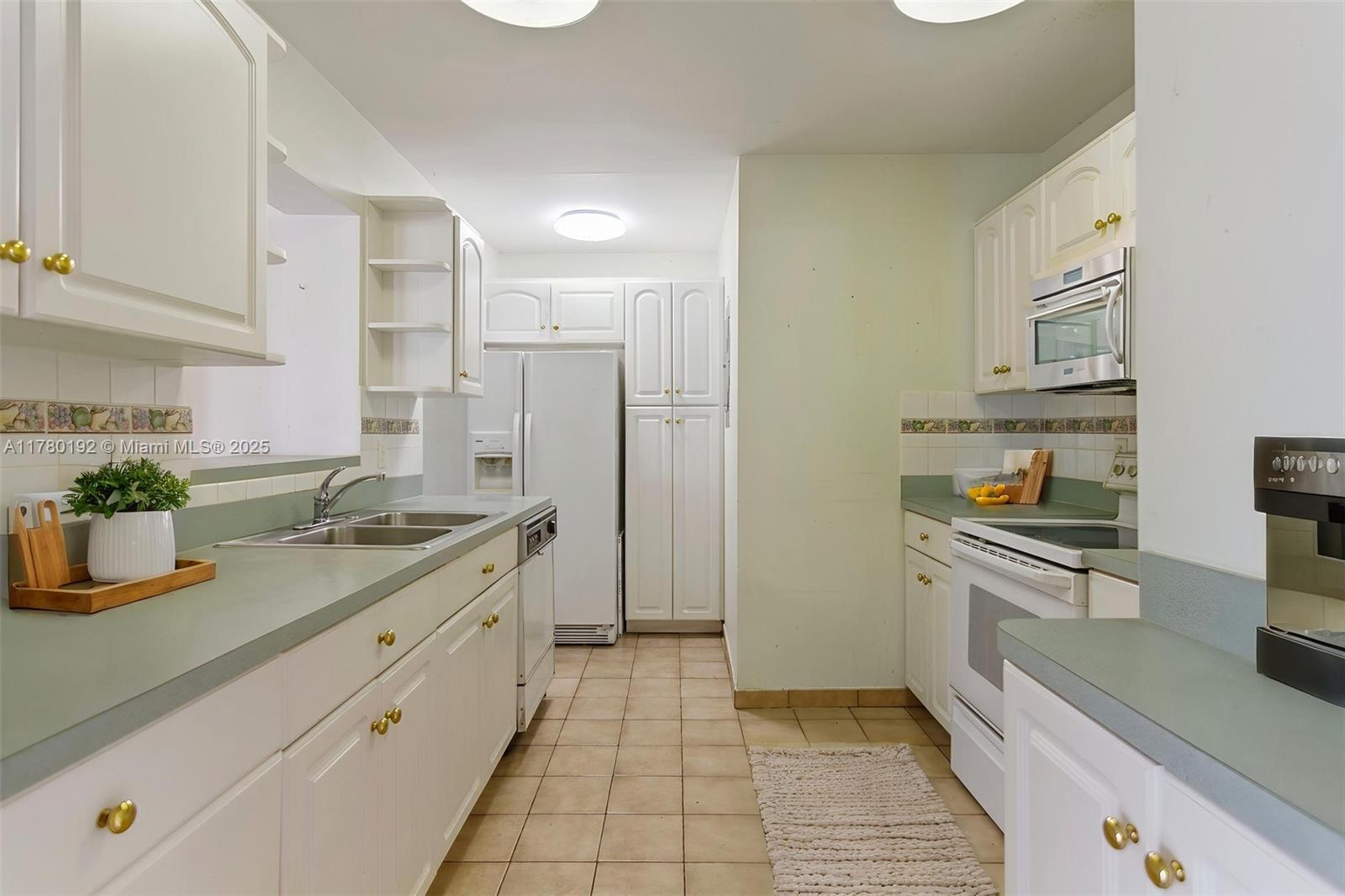 9864 Southwest 26th Terrace Miami, FL 33165 - Photo 14 of 39 a kitchen with stainless steel appliances granite countertop a sink and a stove