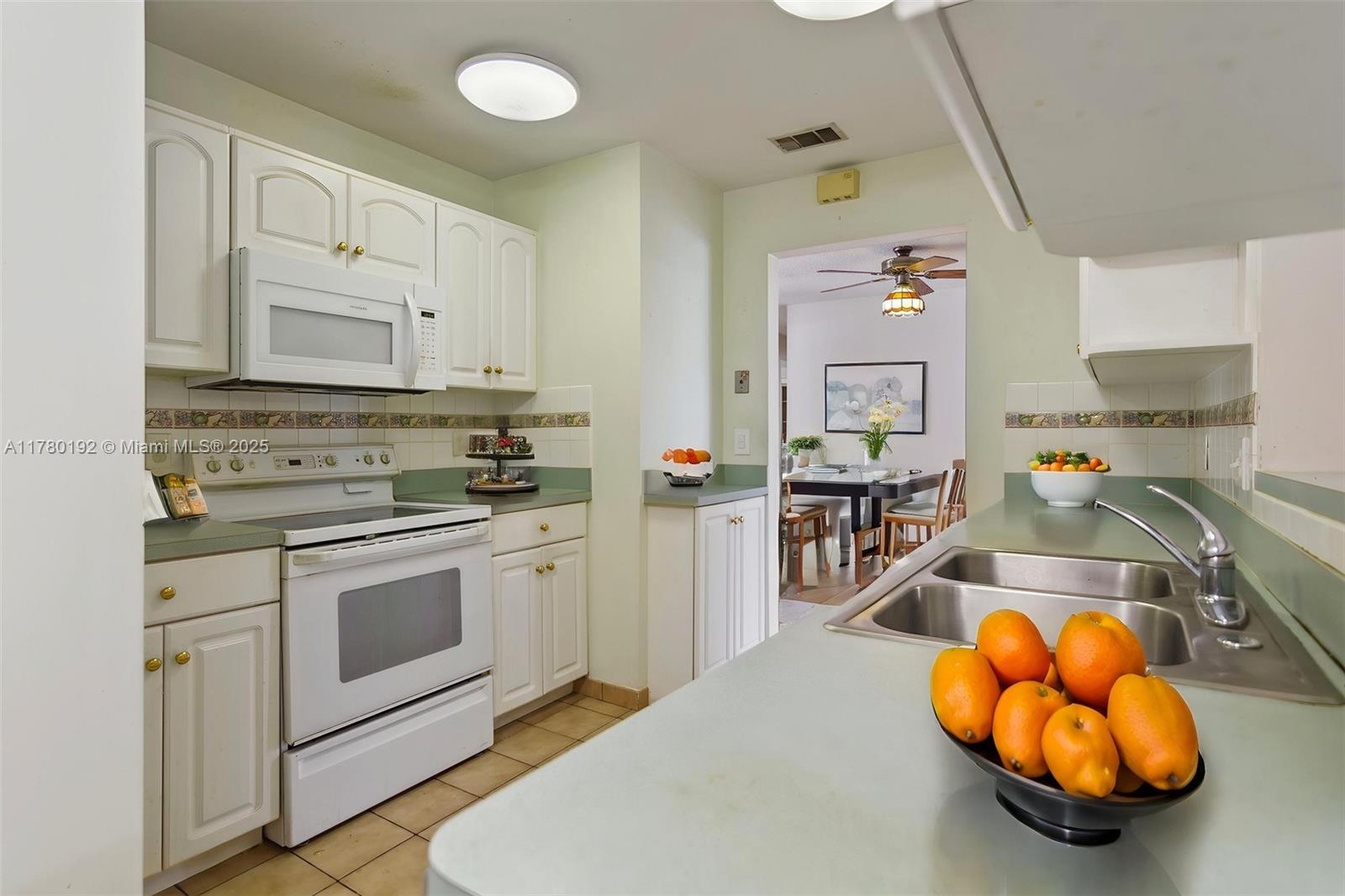 9864 Southwest 26th Terrace Miami, FL 33165 - Photo 16 of 39 a kitchen with stainless steel appliances granite countertop a sink a stove and cabinets