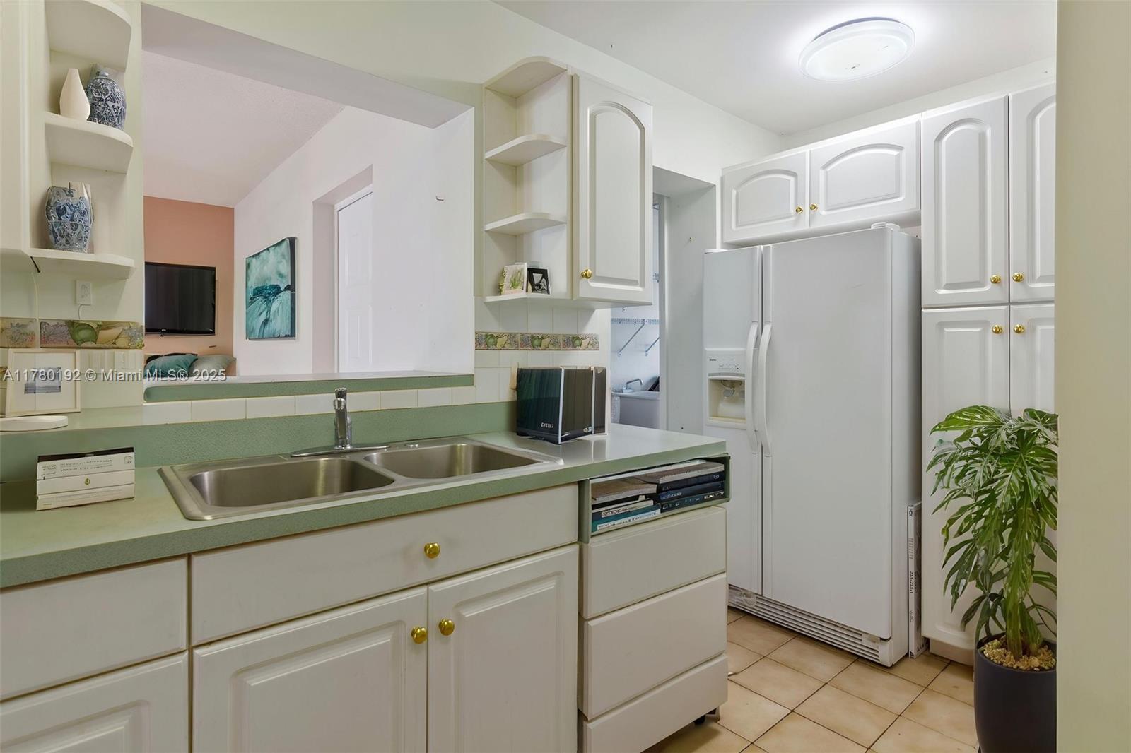 9864 Southwest 26th Terrace Miami, FL 33165 - Photo 20 of 39 a kitchen with appliances a sink and cabinets