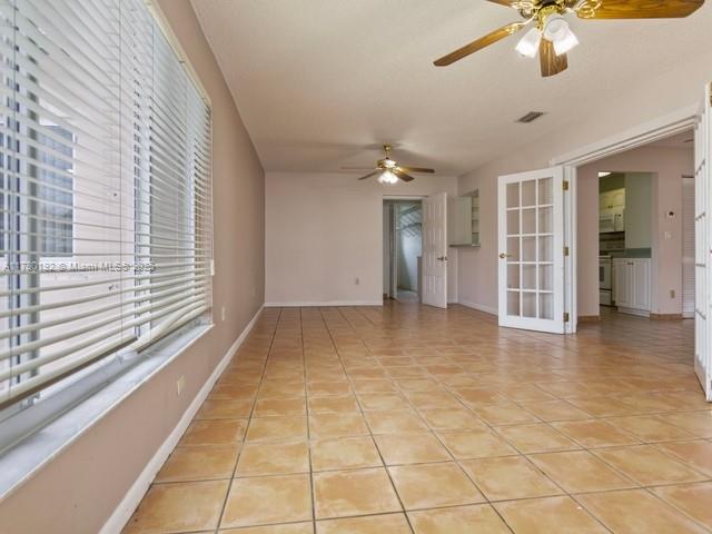 9864 Southwest 26th Terrace Miami, FL 33165 - Photo 21 of 39 a view of empty room with wooden floor and fan