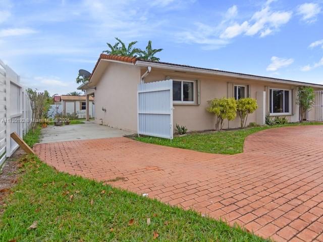 9864 Southwest 26th Terrace Miami, FL 33165 - Photo 39 of 39 a front view of a house with a yard and garage