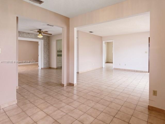 9864 Southwest 26th Terrace Miami, FL 33165 - Photo 6 of 39 an empty room with wooden floor and cabinet