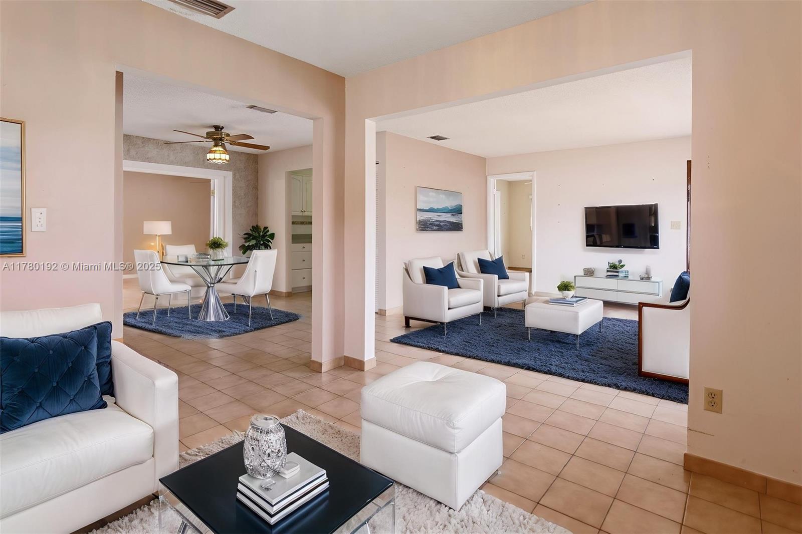 9864 Southwest 26th Terrace Miami, FL 33165 - Photo 7 of 39 a living room with couches and a flat screen tv