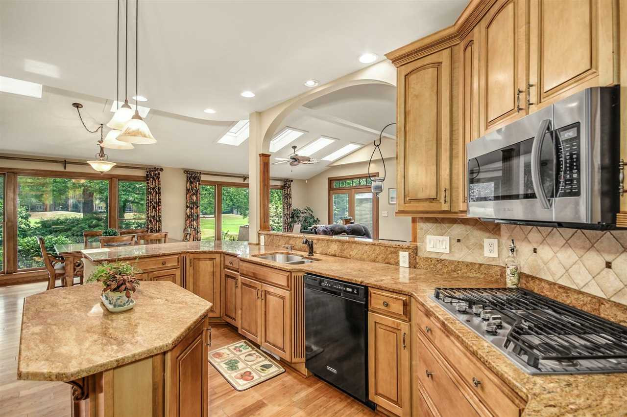 5109 Salem Ridge Road Holly Springs, NC 27540 - Photo 7 of 30 Custom cabinets with sliding pull-outs. Walk-in pantry, gas cooktop, double oven and granite counters. Large open Kitchen