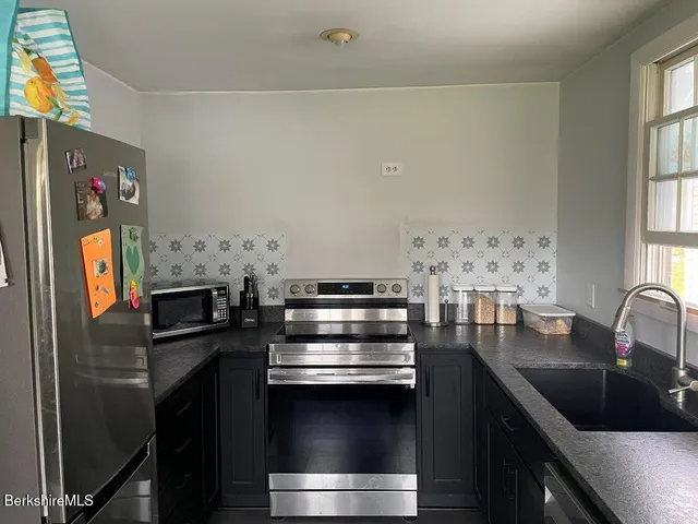 a kitchen with stainless steel appliances a stove and a refrigerator