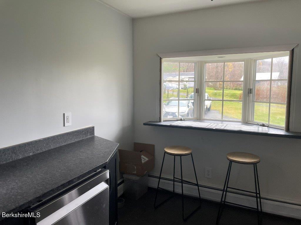 1320 Church Street North Adams, MA 01247 - Photo 8 of 33 a kitchen with a table chairs and a stove