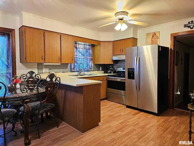 a kitchen with stainless steel appliances granite countertop a refrigerator stove and sink