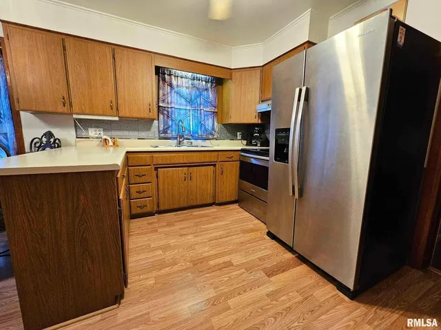 a kitchen with stainless steel appliances and wooden cabinets