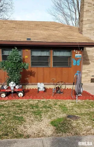 a view of a backyard with table and chairs under an umbrella