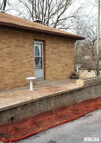 a front view of a house with outdoor seating