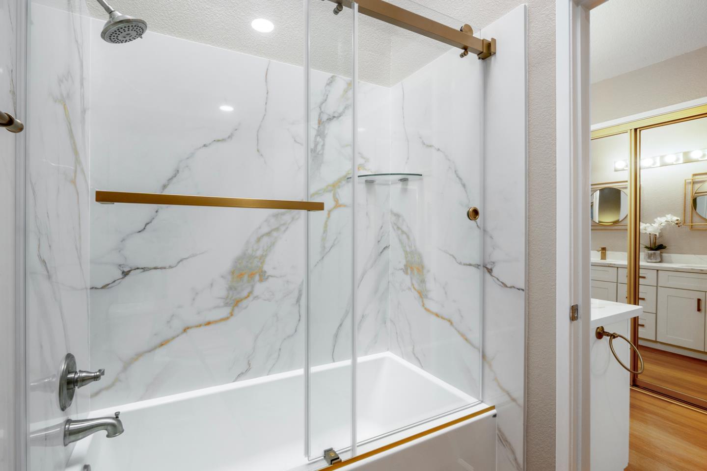 2153 Darnis Circle Morgan Hill, CA 95037 - Photo 18 of 33 a bathroom with a glass shower door and a sink