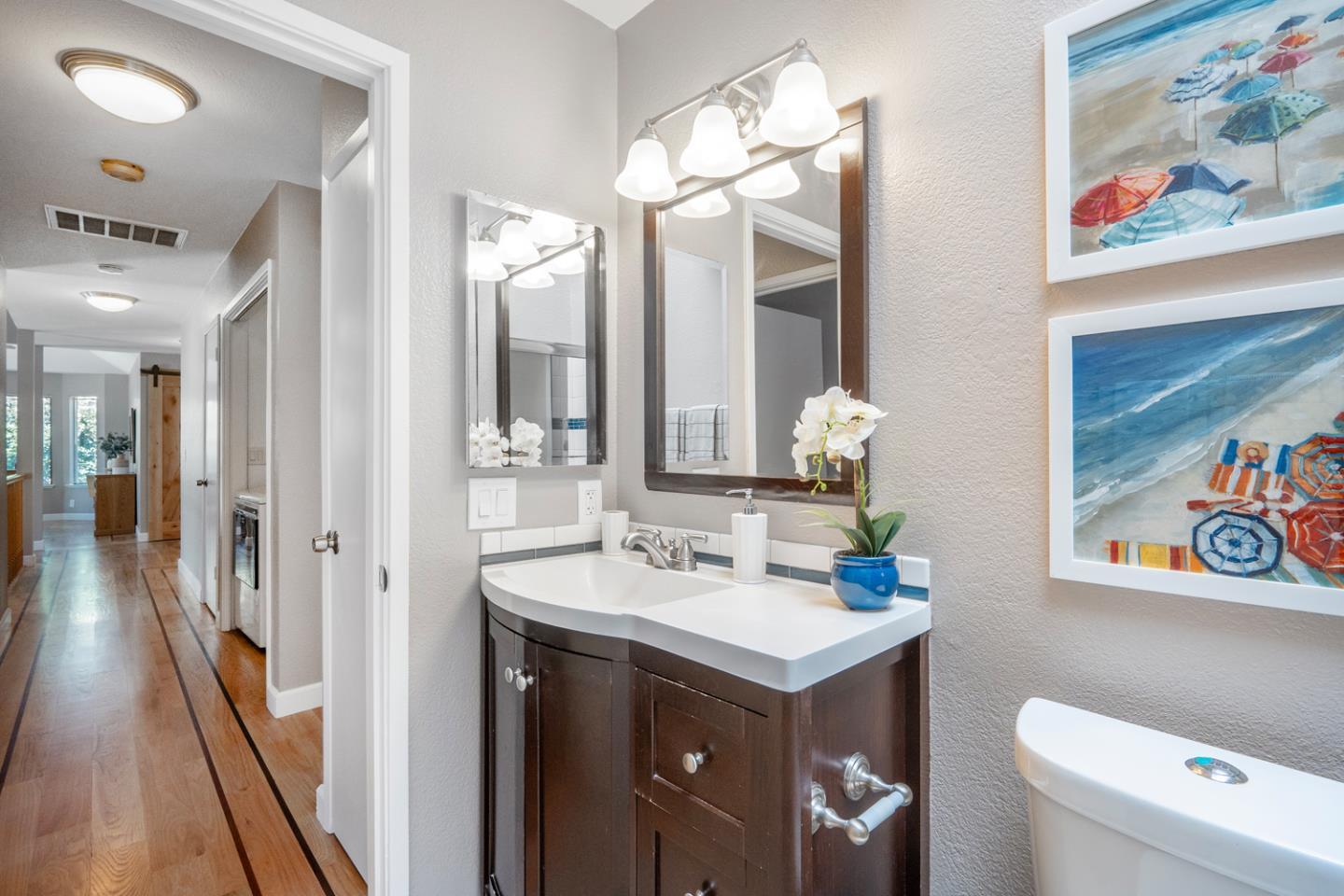 2153 Darnis Circle Morgan Hill, CA 95037 - Photo 24 of 33 a bathroom with a sink vanity mirror and toilet