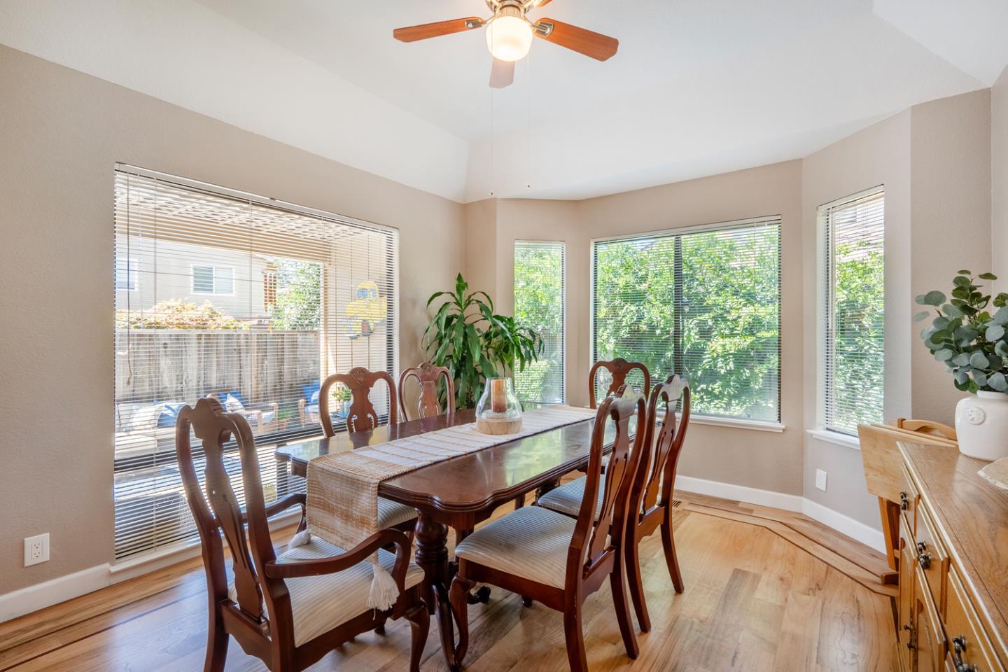 2153 Darnis Circle Morgan Hill, CA 95037 - Photo 7 of 33 a dining room with furniture a chandelier and wooden floor
