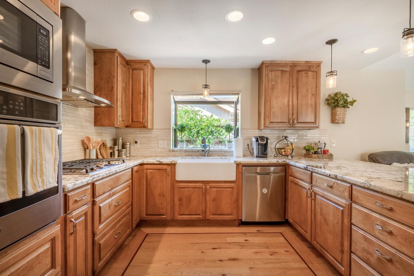 2153 Darnis Circle Morgan Hill, CA 95037 - Photo 9 of 33 a kitchen with a sink window and cabinets
