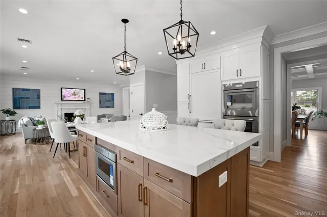 a view of kitchen island of center island wooden floor and living room view