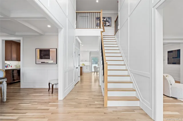 a view of a hallway with stairs and a fireplace