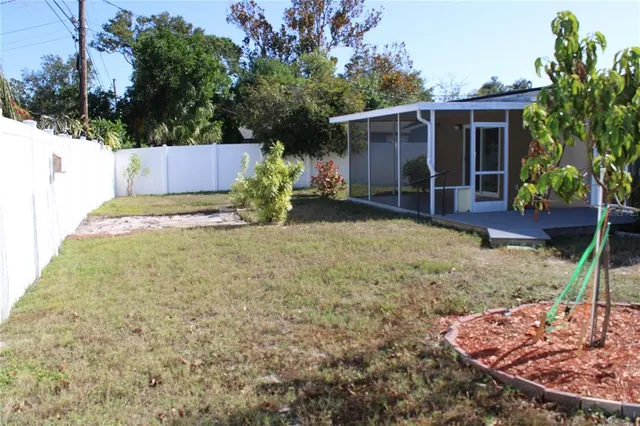 a view of a house with a yard and potted plants