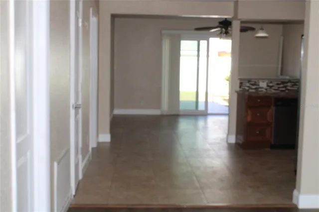 a view of hallway with wooden floor and windows