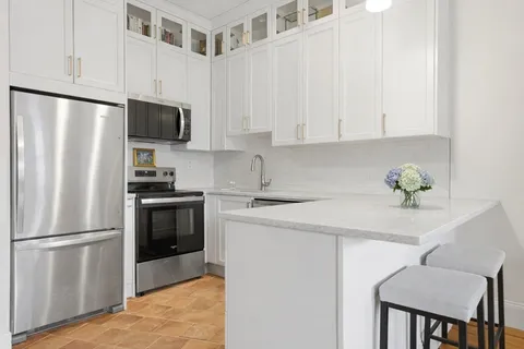 a kitchen with stainless steel appliances a refrigerator sink and microwave