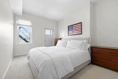 a bedroom with a bed and a window
