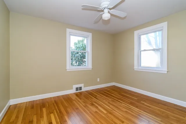 a view of a room with wooden floor and windows