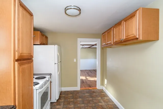 a view of a kitchen with a sink and refrigerator