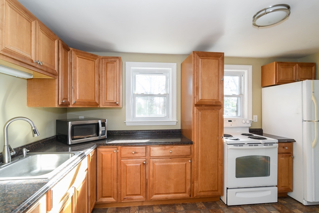 7 Ferndale Road Natick, MA 01760 - Photo 8 of 24 a kitchen with stainless steel appliances granite countertop a stove a sink and a refrigerator