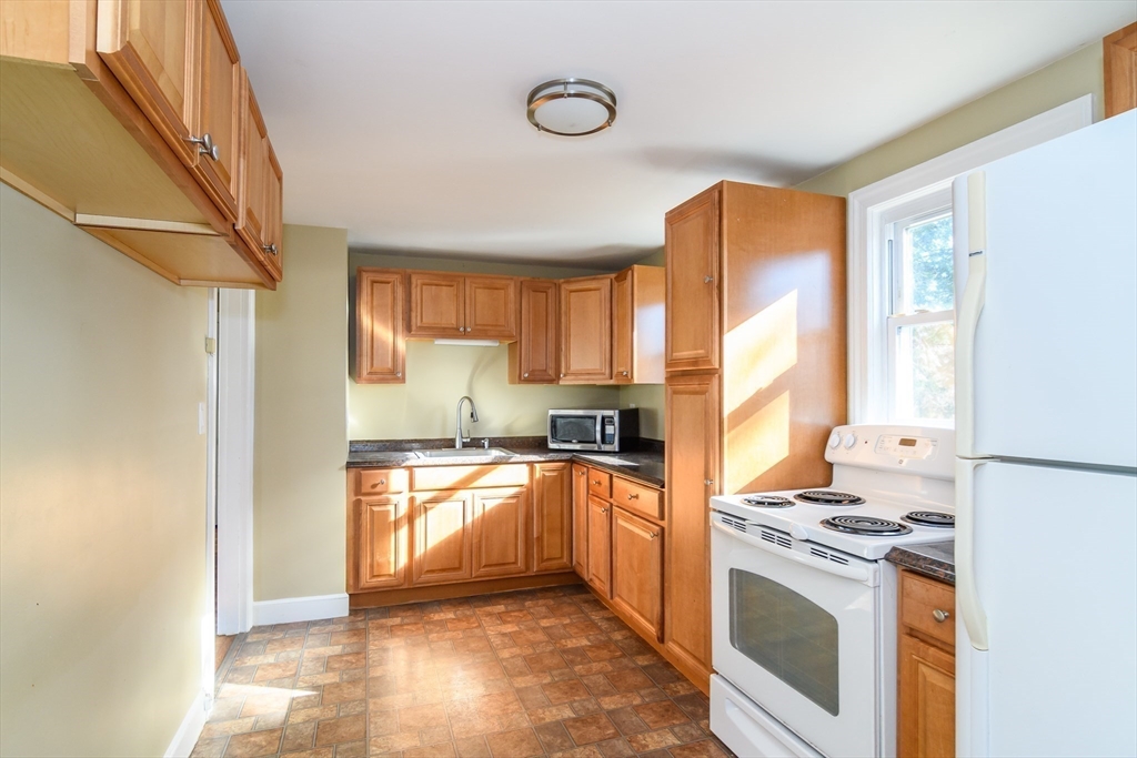 7 Ferndale Road Natick, MA 01760 - Photo 9 of 24 a kitchen with stainless steel appliances granite countertop a stove a sink and a refrigerator
