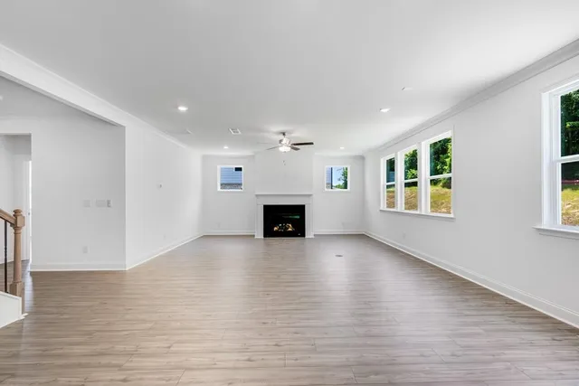 a large kitchen with stainless steel appliances granite countertop a stove a sink dishwasher and a refrigerator with wooden floor