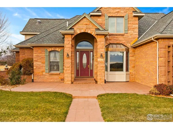 a view of a brick house with large windows