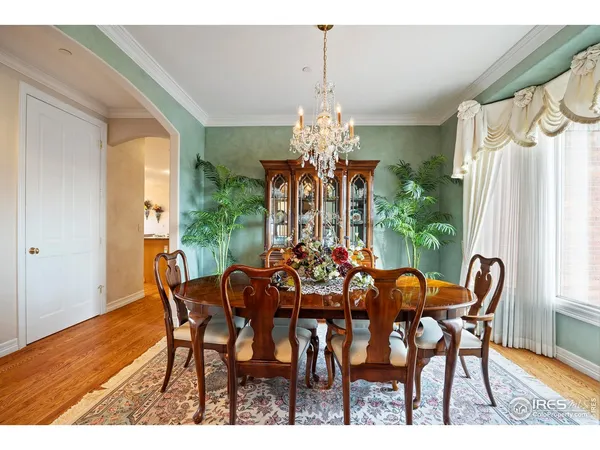 a view of a dining room with furniture and chandelier