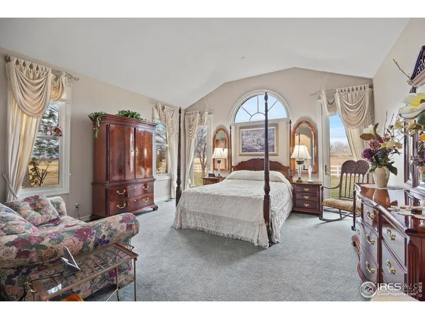 a living room with furniture flat screen tv and a large window