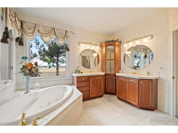 a spacious bedroom with a bed a mirror and desk