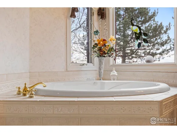 a en suite bathroom with a granite countertop double vanity sink and a mirror