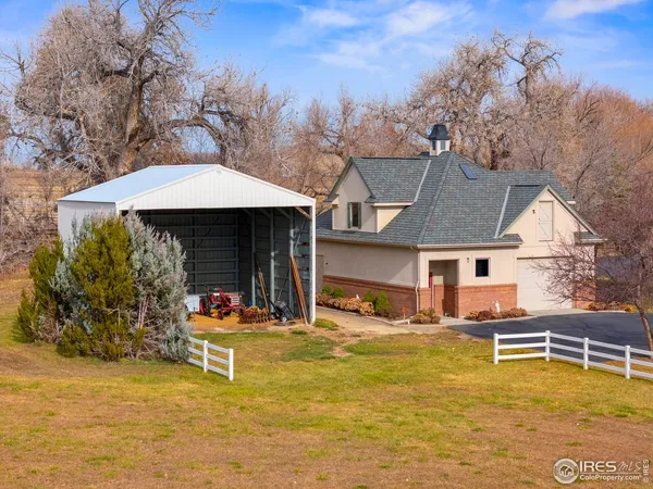 a view of a house with backyard patio and sitting area