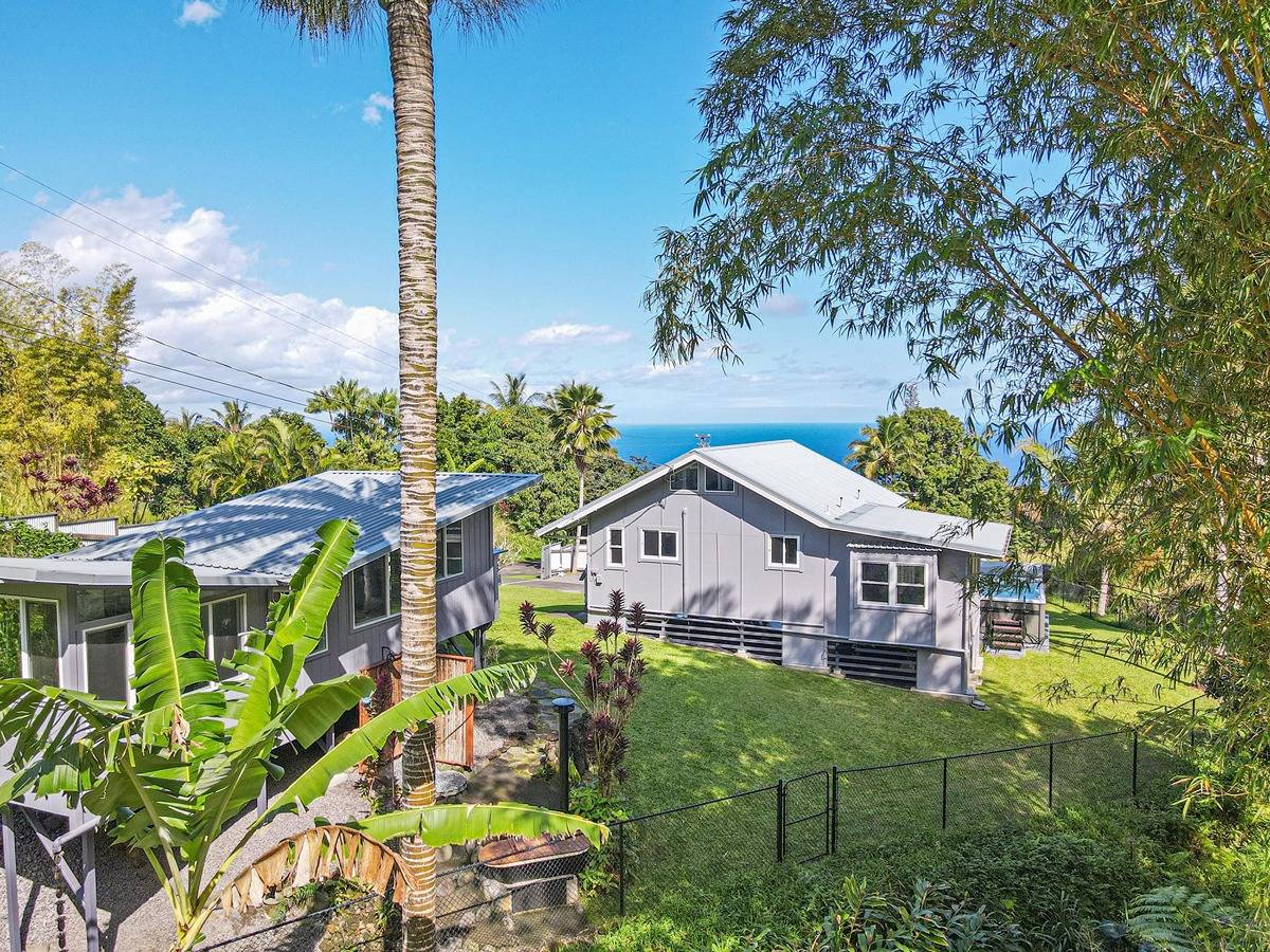 Just under 1 acre this property includes a carport with plenty of storage, main one bedroom home, detached 1 bedroom cottage, 2 outdoor showers, soaking tub, pool, owned grid-tied solar,  privacy fencing, large lanais and county water.