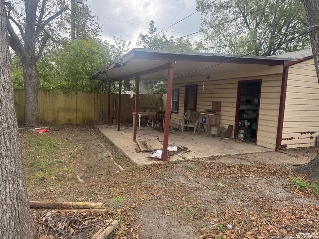 a backyard of a house with barbeque oven