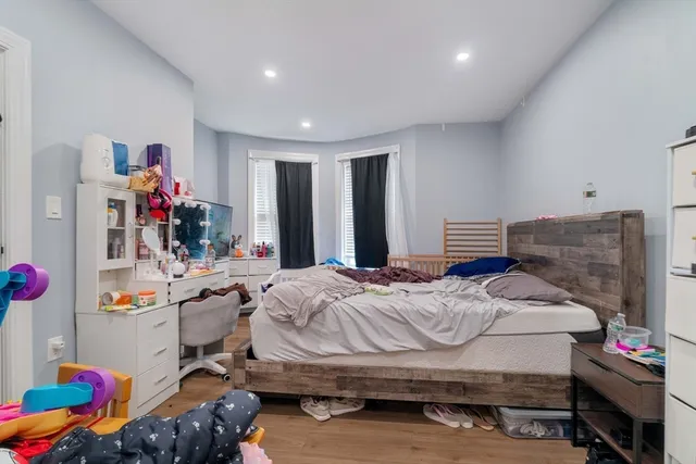 a bedroom with a bed and a chandelier