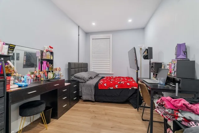 a bedroom with a bed and a desk