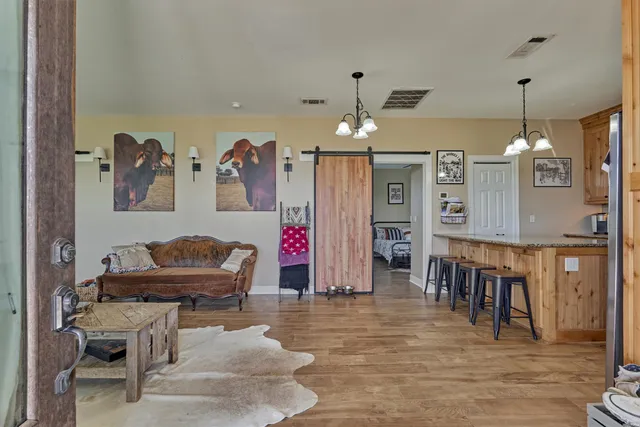 a living room with lots of furniture and kitchen view
