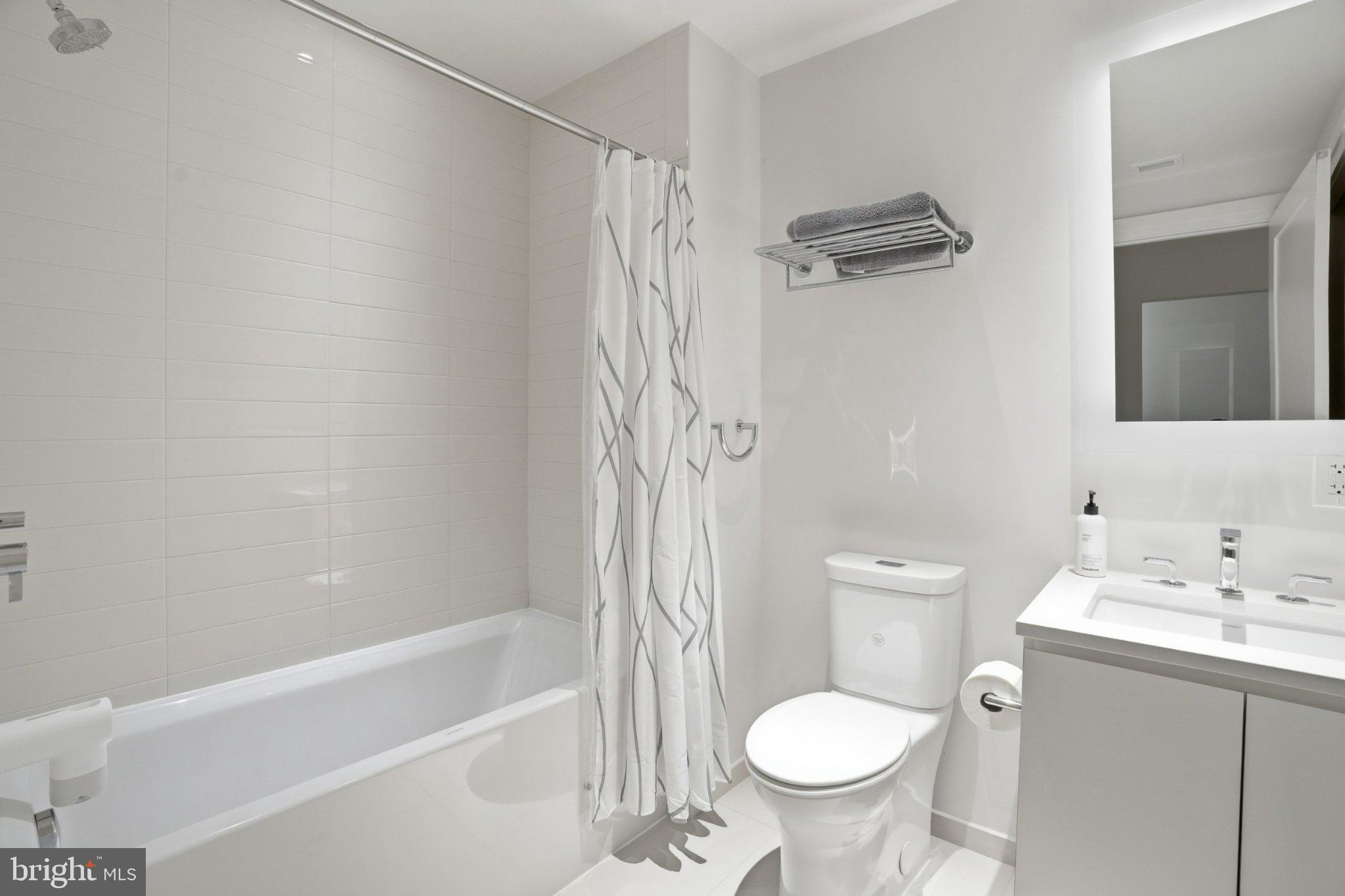 2501 M Street Northwest, Unit 209 Washington, DC 20037 - Photo 12 of 48 a bathroom with a toilet sink and shower