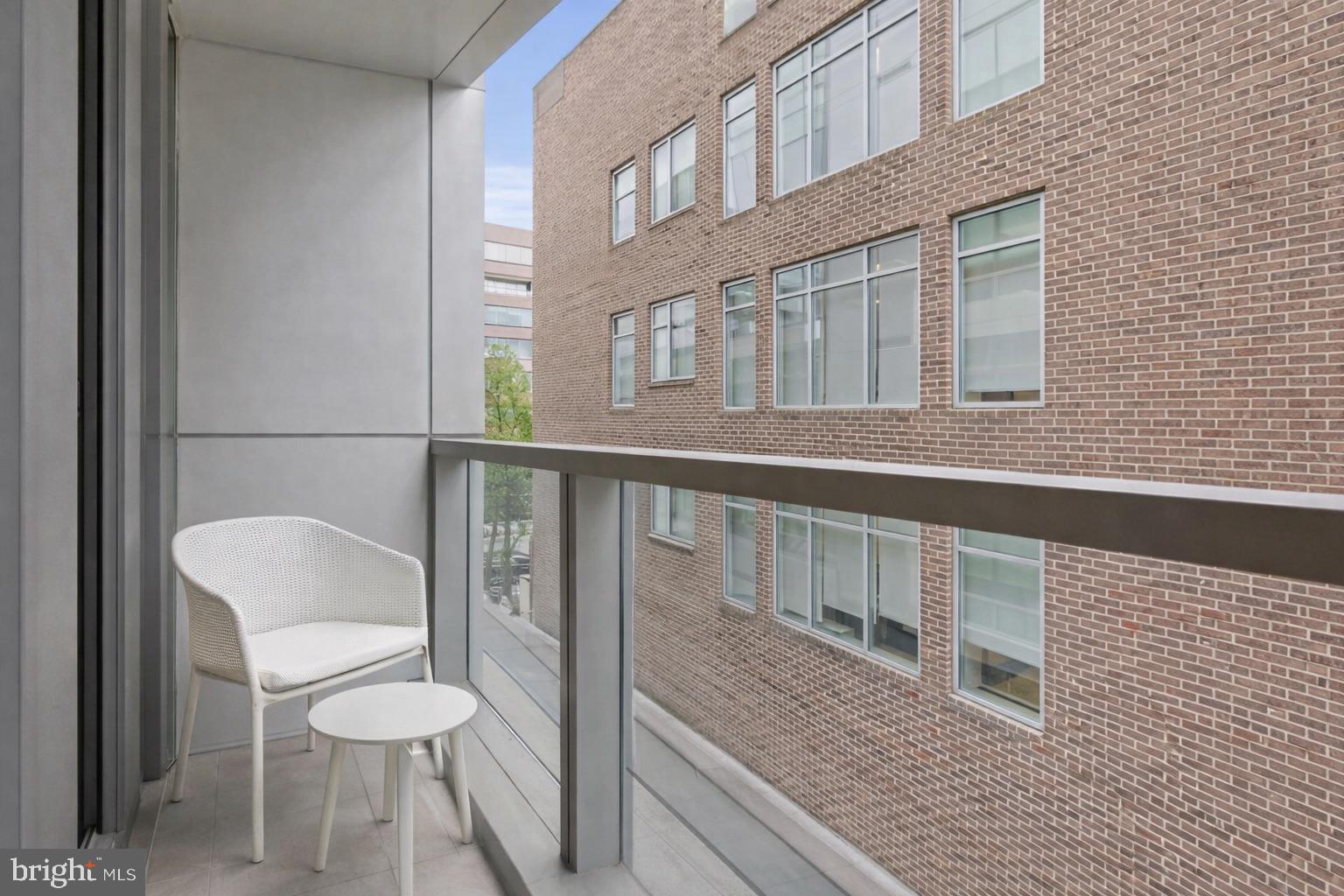 2501 M Street Northwest, Unit 209 Washington, DC 20037 - Photo 19 of 48 a balcony with table and chairs