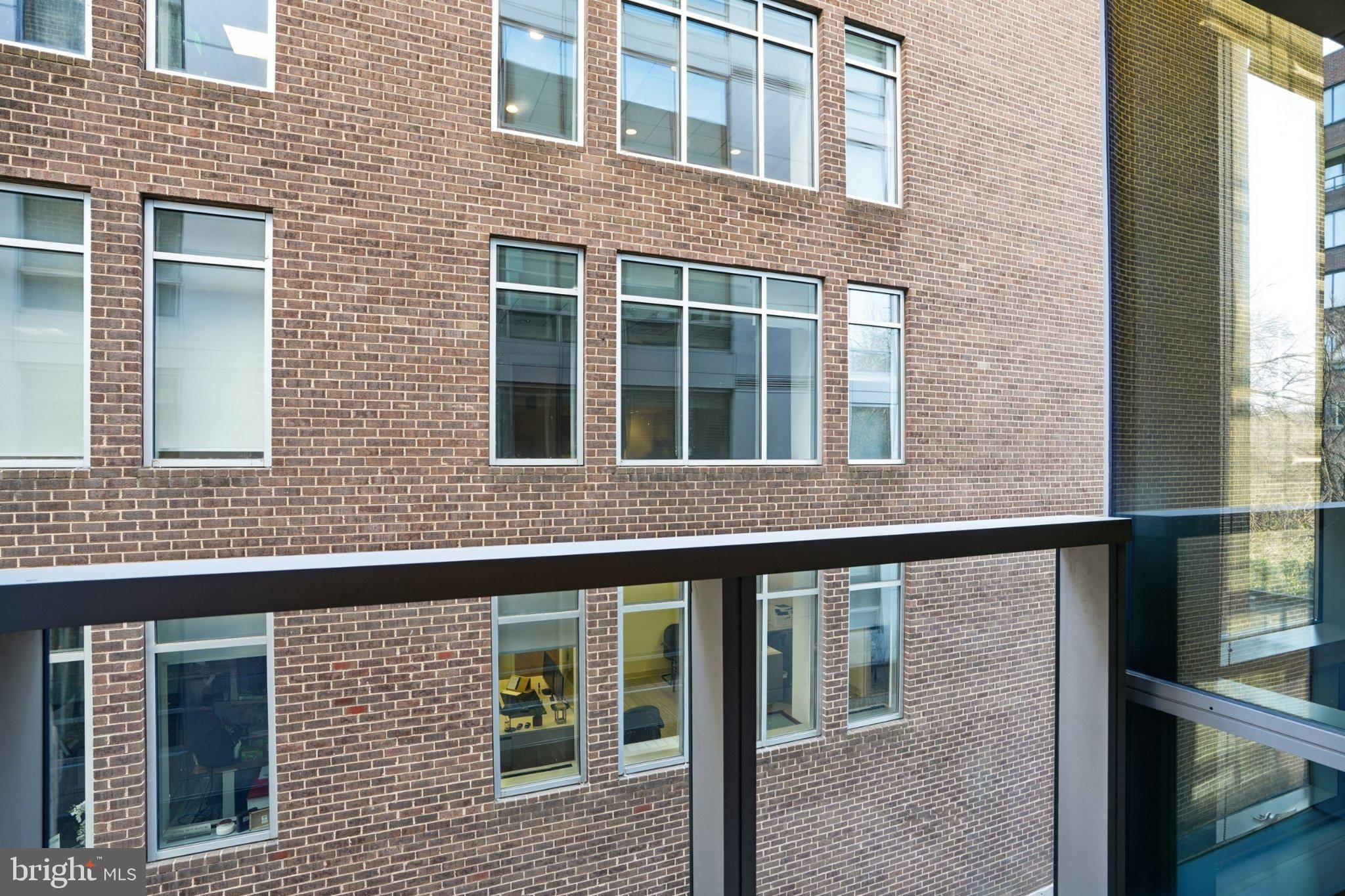 2501 M Street Northwest, Unit 209 Washington, DC 20037 - Photo 20 of 48 a view of a brick building next to a yard