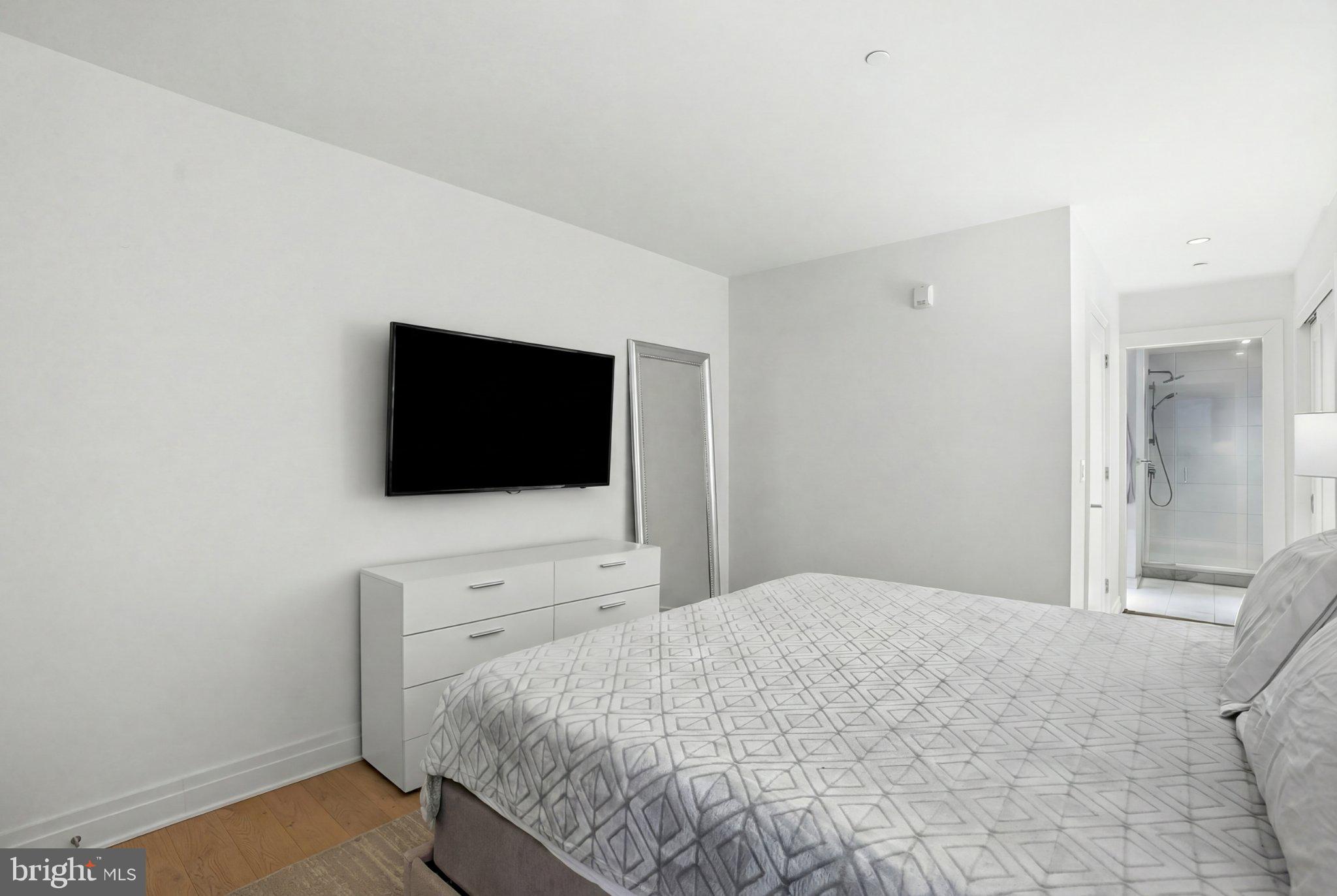 2501 M Street Northwest, Unit 209 Washington, DC 20037 - Photo 21 of 48 a bedroom with a bed and a flat screen tv